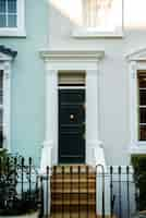 Free photo front view of front door with blue and white wall and plants