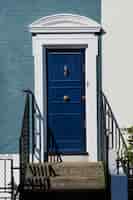 Free photo front view of front door with blue and white wall