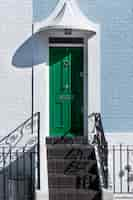 Free photo front view of front door with white and blue wall