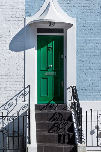 Front view of front door with white and blue wall