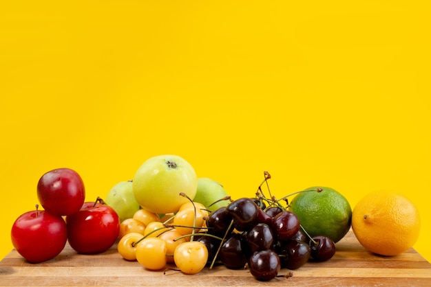 A front view fruit composition mellow and juicy on yellow, fruit summer color