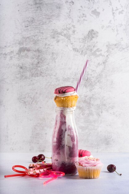 Front view of fruit dessert with muffins and straw