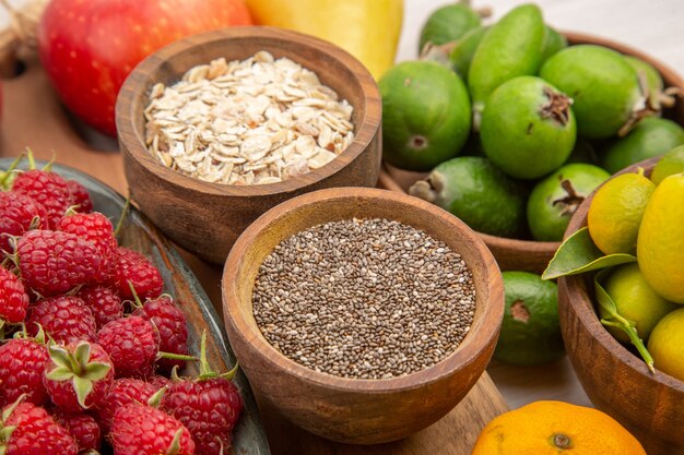 Front view fruits composition on white desk tropical ripe color exotic mellow diet photo