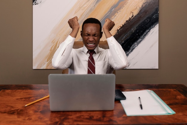 Front view frustrated man sitting at desk