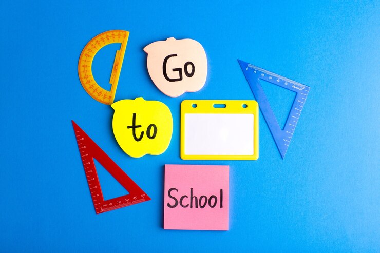 Free Photo front view geometric figures with different colored stickers on the blue surface