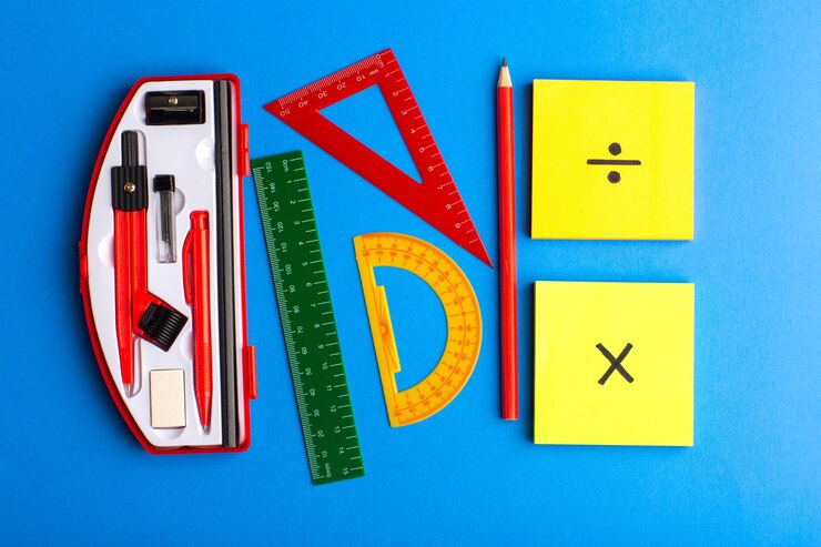 Front view geometric figures with pencil and stickers on blue surface