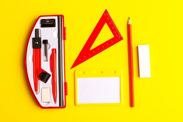 Front view geometric figures with pencil on the yellow surface