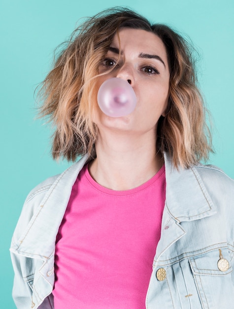 Front view girl blowing bubble gum