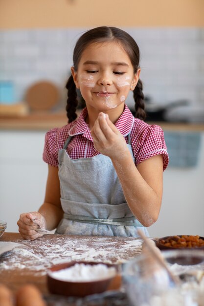 Front view girl cooking at home