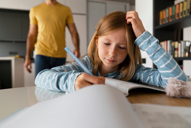 Front view girl doing homework