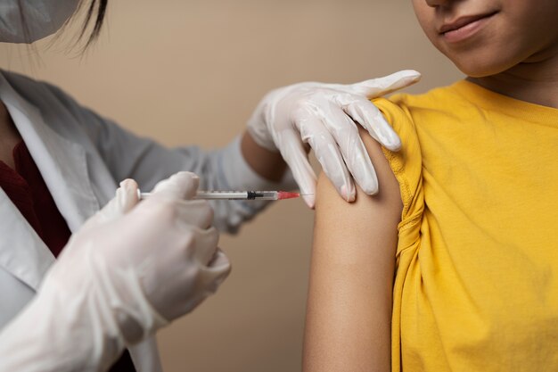 Front view girl getting vaccinated