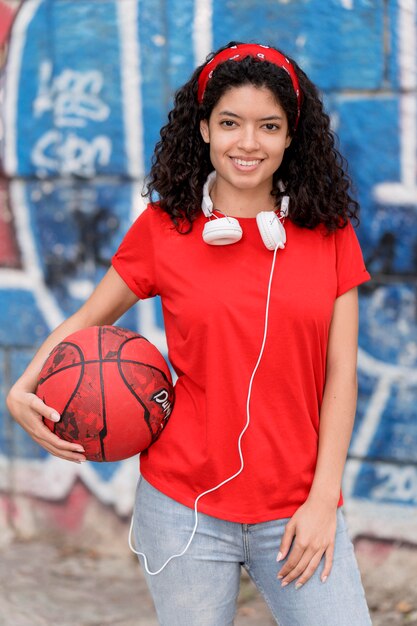 Front view girl holding basket ball