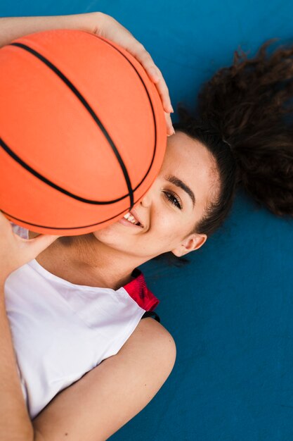 Front view of girl holding a basketball ball