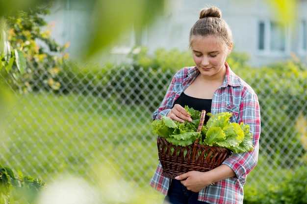 Front view girl holding lettuce basket