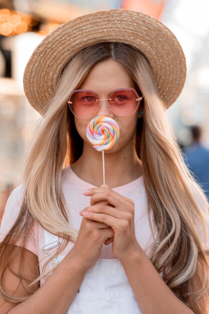 Free photo front view girl holding lollipop