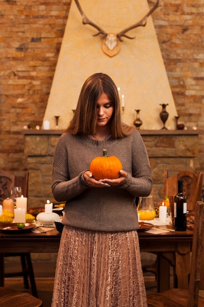 Front view girl holding pumpkin