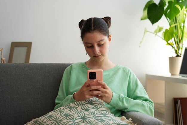 Free photo front view girl holding smartphone