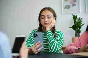 Free photo front view girl holding smartphone