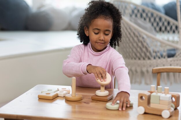 Front view girl kid playing with eco toys