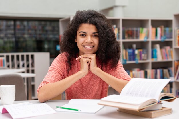 Front view girl at library studying