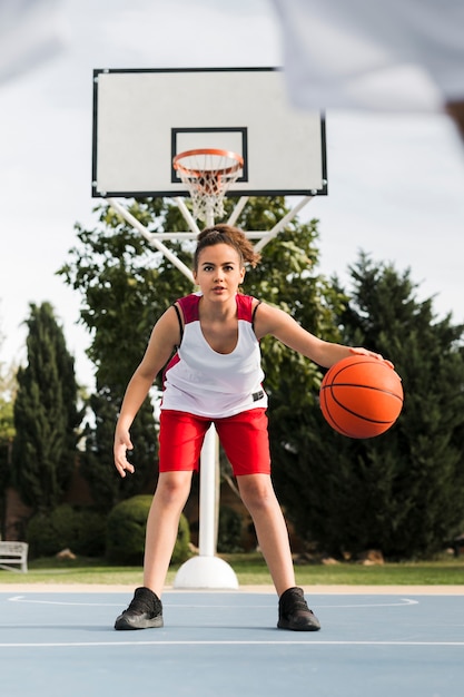 Front view of girl playing basket