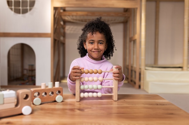 Free photo front view girl playing with ecological toys