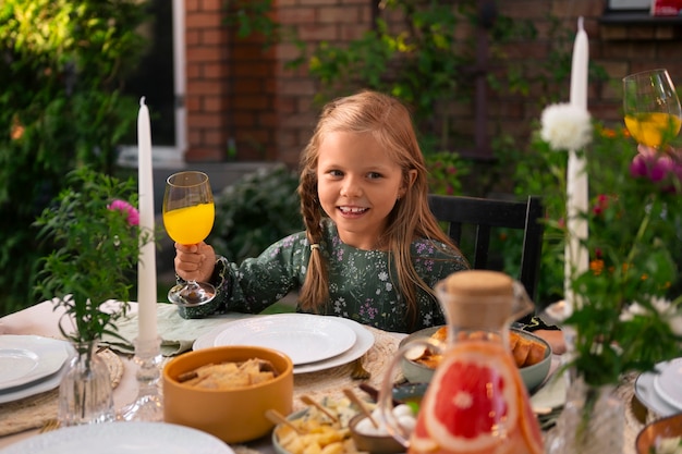 Free photo front view girl sitting at table