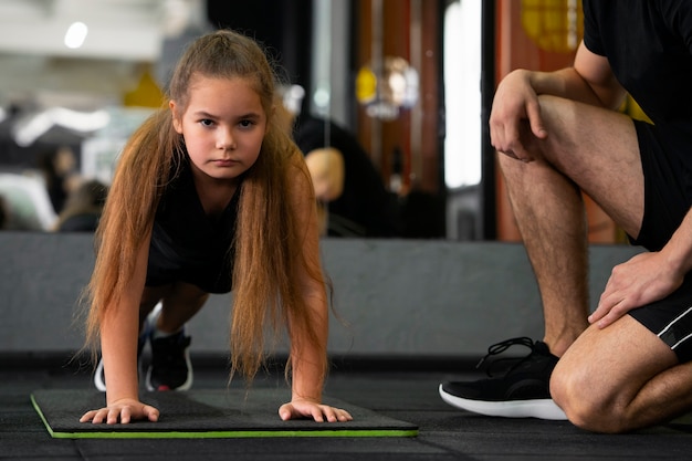 Free photo front view girl training at gym