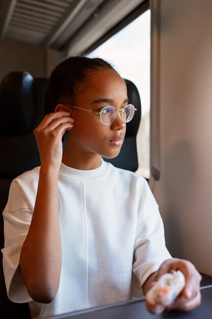 Free photo front view girl traveling by train