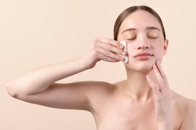 Free photo front view girl using gua sha