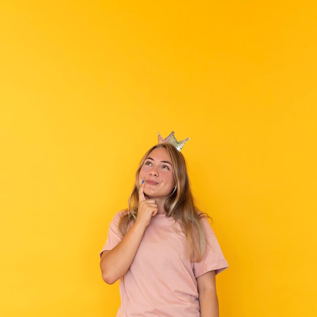 Front view of girl wearing a crown with copy space