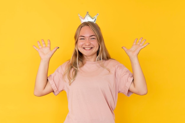 Free photo front view of girl wearing a crown with copy space