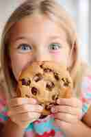 Free photo front view girl with delicious cookie