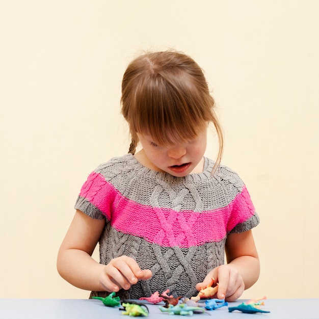 Front view of girl with down syndrome and toys