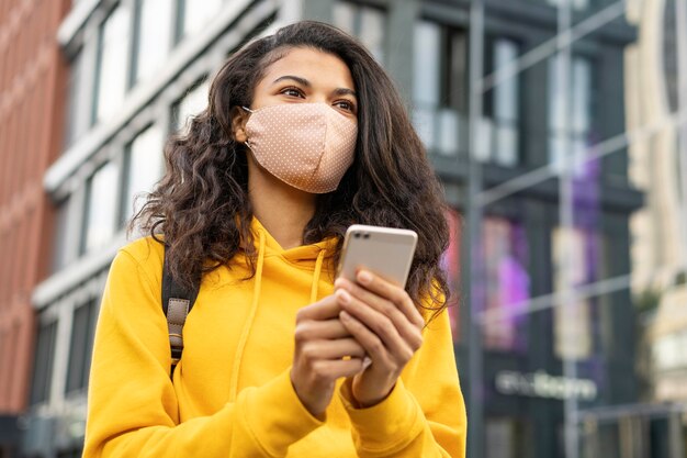 Front view of girl with face mask on street