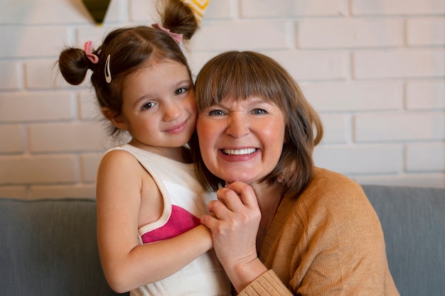 Front view girl with granny at home