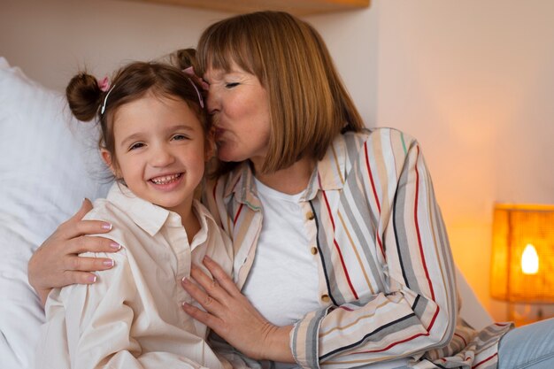 Front view girl with granny at home