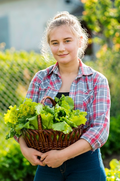 Free photo front view girl with lettuce basket