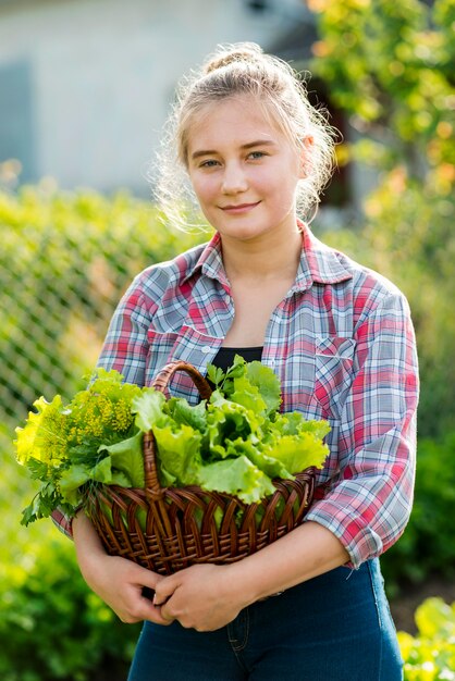 Front view girl with lettuce basket