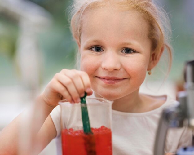 Front view girl with science experiment