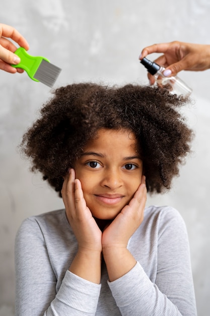 Ragazza di vista frontale con trattamento spray