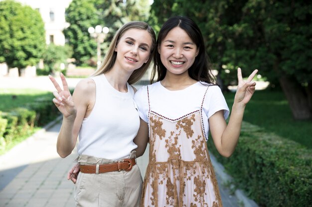 Front view girls doing the peace sign