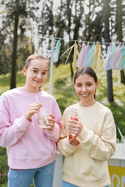 Front view girls drinking lemonade