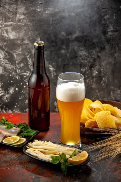 Front view glass of bear with cheese cips and fish on light snack wine photo color alcohol