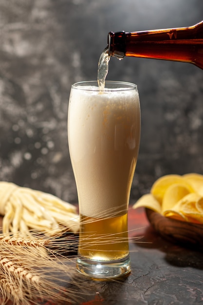 Front view glass of bear with cips on a light wine color photo alcohol drink snack