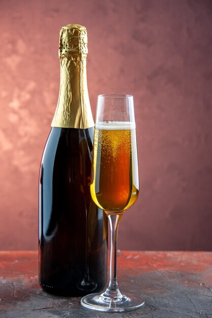 Вид спереди бокал шампанского с бутылкой на легком напитке алкоголь фото цвет шампанское новый год