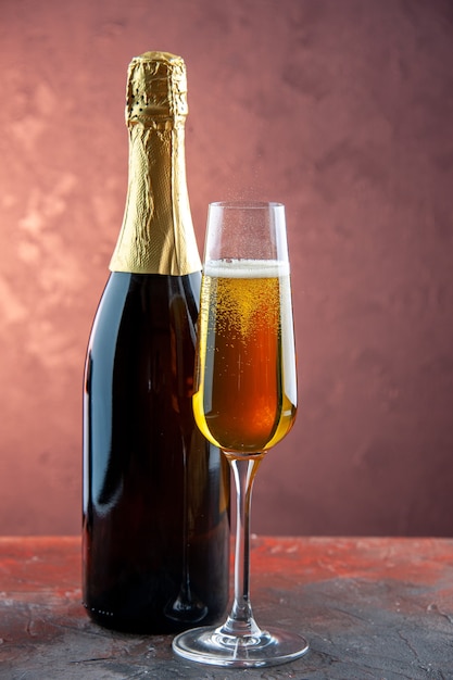 Front view glass of champagne with bottle on a light drink alcohol photo color champagne new year