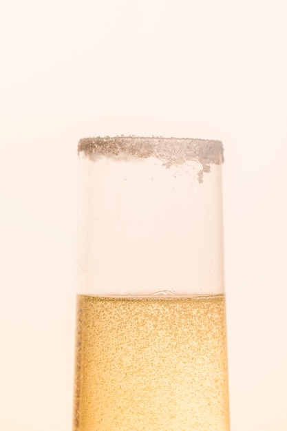 Front view glass half filled with sparkle champagne