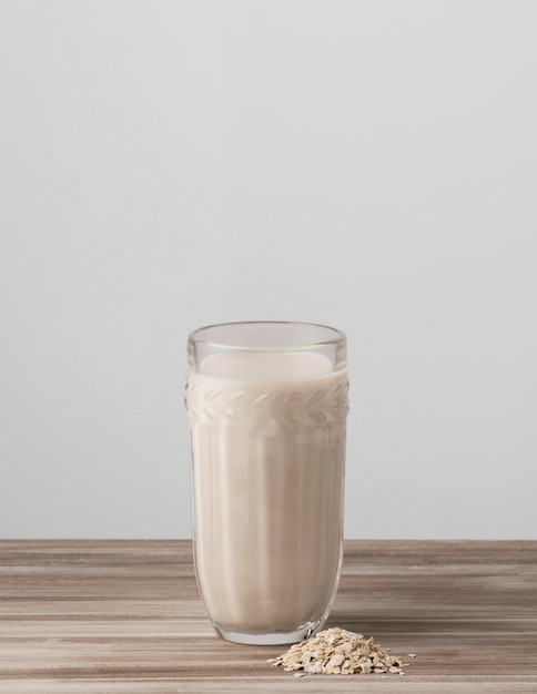 Front view of glass of milk with oatmeal