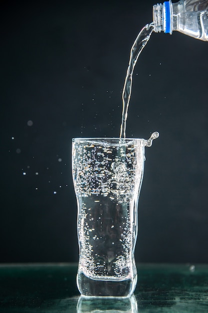 Front view glass of soda getting poured on a dark drink photo champagne xmas water